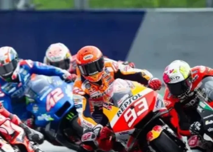 Com certeza! Com base na descrição detalhada e no guia, aqui estão as sugestões de legenda, título e texto alternativo para a imagem, focando no contexto do MotoGP e do Brasil 2026: Sugestões para a Imagem: Título: Aceleração Máxima: O Retorno Estrondoso da MotoGP ao Brasil em 2026 Legenda: "Motores rugindo e disputas milimétricas em uma curva de tirar o fôlego! Esta imagem captura a essência da MotoGP, antecipando a adrenalina que tomará conta do Brasil em 2026. Pilotos no limite, como o icônico #93 da Repsol Honda e a poderosa Ducati em primeiro plano, mergulham em uma batalha intensa, simbolizando o espetáculo inesquecível que aguarda os fãs brasileiros no retorno do Grande Prêmio. Prepare-se para a velocidade, a paixão e a história sendo reescrita!" Texto Alternativo (Alt Text): "Um grupo de motocicletas de MotoGP, incluindo a Repsol Honda #93 e uma Ducati vermelha, em intensa disputa em uma curva para a direita. Os pilotos estão em alta inclinação, com os cotovelos próximos ao asfalto, mostrando a perícia e a velocidade da corrida."